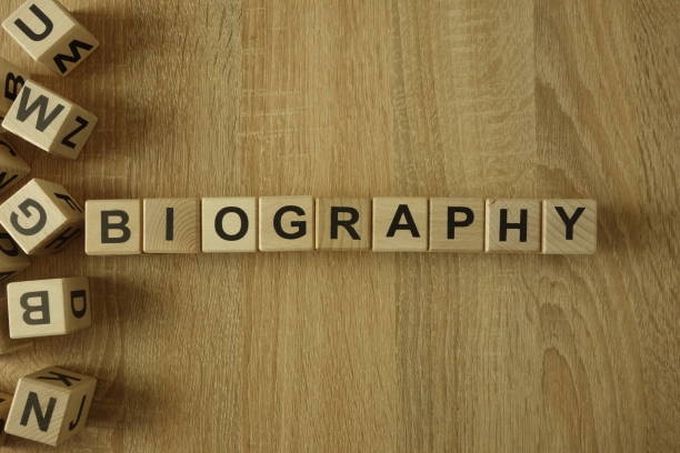 Biography word from wooden blocks on desk